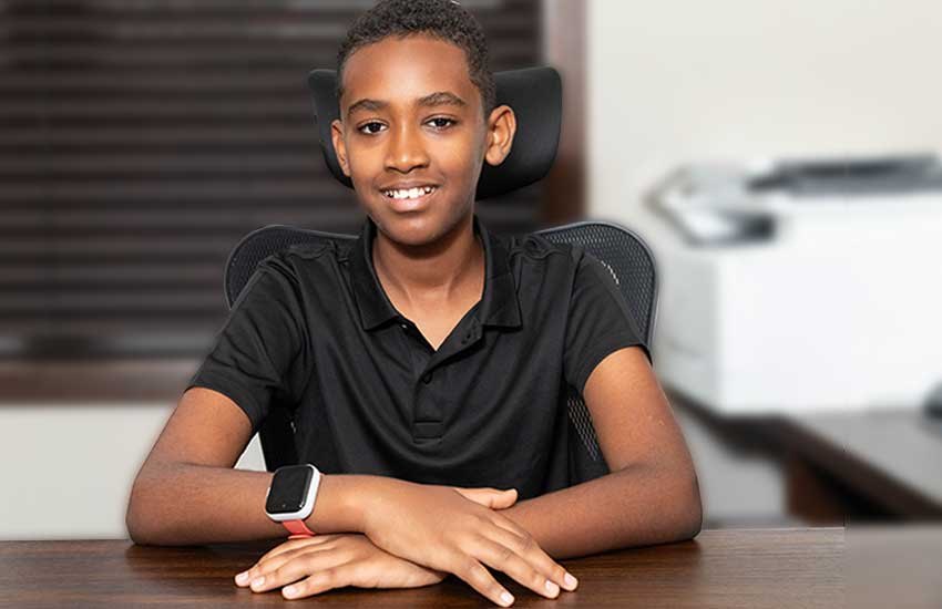 Hayuu Seeroo smiling at his desk